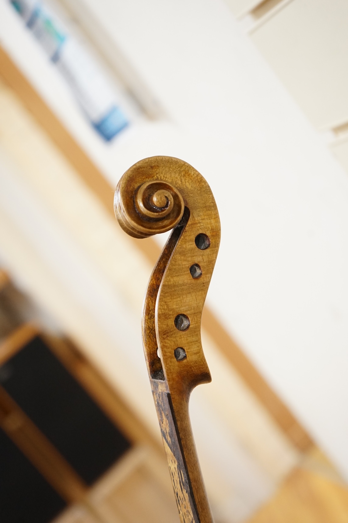 Three cased violins; a German Dresden violin, supplied by Campbell and co., Glasgow, together with another Dresden Stradivarius copy, and the remains of a European violin.